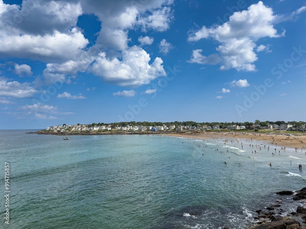 Fototapeta August vacationers enjoy a sunny Summer afternoon at York's Short Sands beach