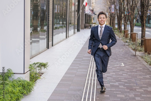 Fototapeta 爽やかに駆け抜けるビジネスマン