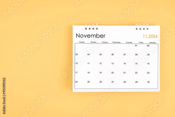 Fototapeta November 2024 desk calendar on yellow color background, position with copy space.