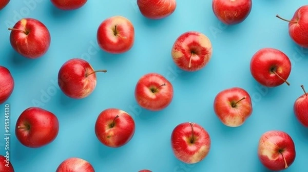 Obraz Top view of vibrant red apples pattern on blue background