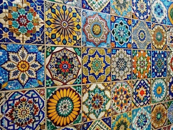 Fototapeta Vibrant colored tiles meticulously arranged to form intricate patterns and designs on a stunning mosaic wall, showcasing craftsmanship and attention to detail.