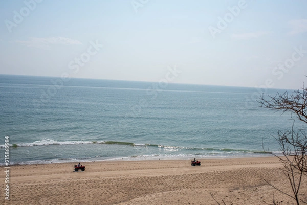 Obraz two people ride along the beach in cape cod
