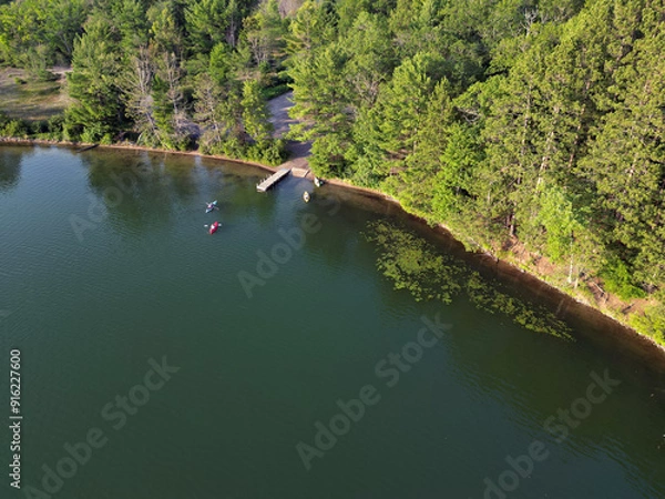 Fototapeta kayak.s on calm northern lake in summer