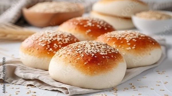 Fototapeta   A group of buns sits on a table next to bowls of oatmeal