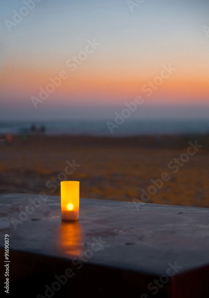 Obraz Candle on a beach sunset