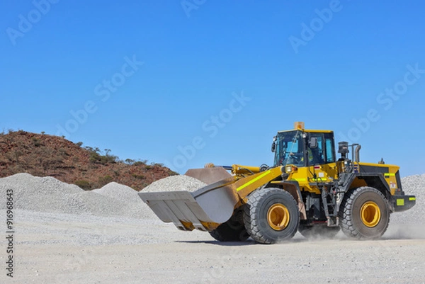 Fototapeta Front-end loader (bucket loader, payloader, high lift, scoop, shovel dozer, skid-steer, skip loader, tractor loader or wheel loader) moving ore, mine, Outback Western Australia