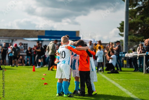 Obraz Group of Young Boy Football Players Coming Together to Team Up and Win the Game