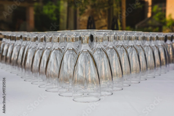 Fototapeta Symmetrical Arrangement of Upside-Down Wine Glasses at Event