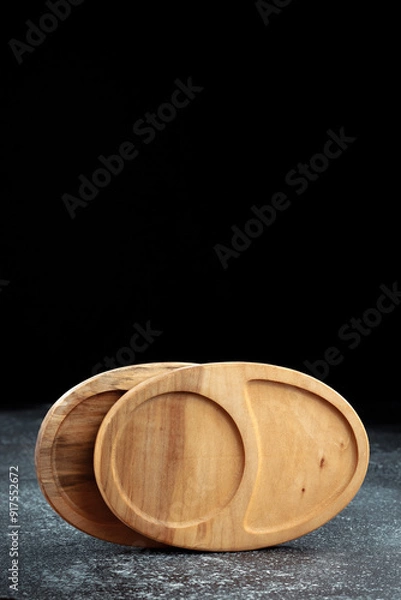 Fototapeta The sideboard is made of wood for serving snacks, fruits, nuts, cheeses, meats and original serving of main dishes. Luxury products from hard and exotic wood species. Accessories for a modern kitchen.