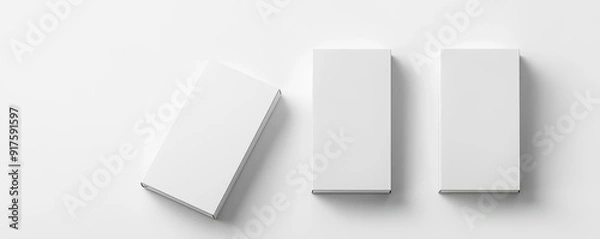 Fototapeta Minimalistic top view of three white rectangular boxes on a white background. Ideal for design presentations, branding, and packaging concepts.