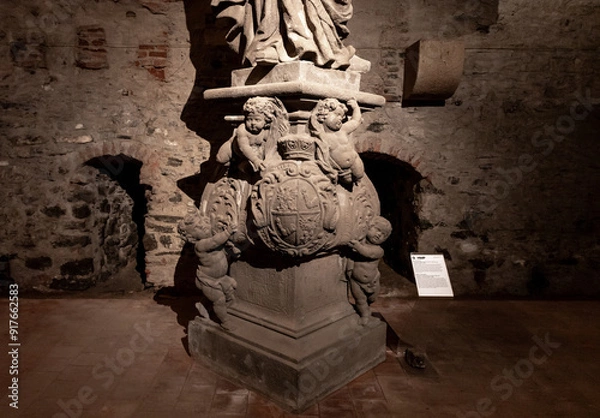 Fototapeta The bottom part of the statue of St Adalbert stands in the dungeon under fortress walls in Vysehrad Prague in Czech Republic