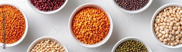 Fototapeta A Rainbow of Legumes: A vibrant array of lentils and beans in white bowls, captured from above in a flat lay composition. Perfect for showcasing healthy eating, vegetarian diets, and global cuisine. 