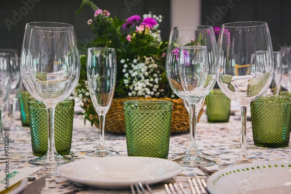 Fototapeta Elegant table setting with crystal glassware and floral centerpiece for formal dining.