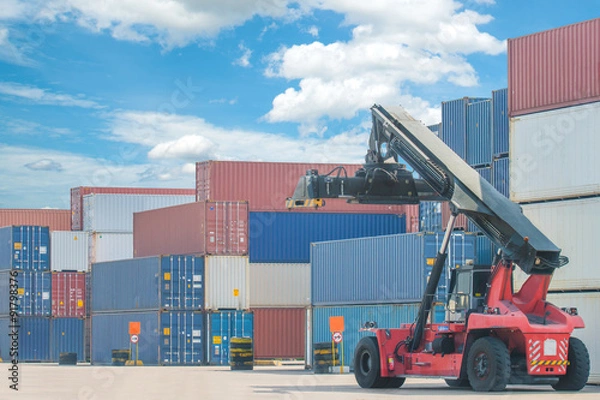 Fototapeta forklift handling container box loading to truck in import expor