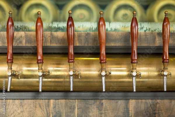 Fototapeta Beer taps inside a pub