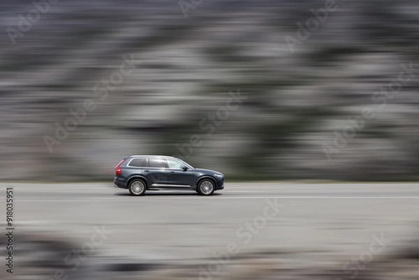 Obraz A moving car. High speed SUV with speed blur background. Side view
