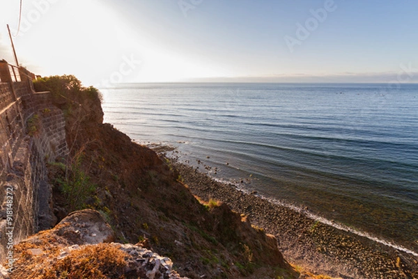 Fototapeta Seascape. Views of Atlantic Ocean from a cliff. Rocky beach. Sunset on the beach. Tenerife, Bajamar, Canary Islands.
