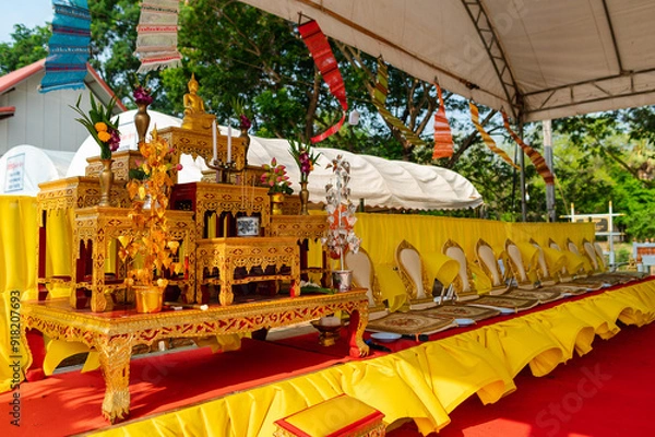 Fototapeta A set of golden altar tables and Buddha seats in religious ceremonial homes. There is a Buddha image placed on the worship table. Thai culture and religion in Thailand