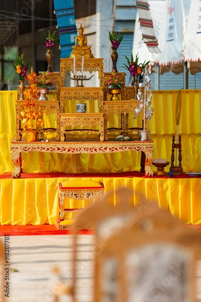 Fototapeta A set of golden altar tables and Buddha seats in religious ceremonial homes. There is a Buddha image placed on the worship table. Thai culture and religion in Thailand