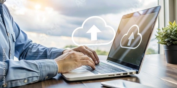 Fototapeta A man is typing on a laptop with a cloud symbol above him