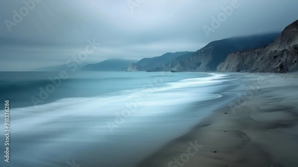 Fototapeta Calm Seaside Landscape With Rocky Shoreline and Snowy Mountains in Overcast Weather