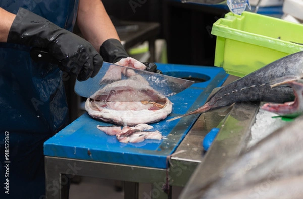 Obraz fishmonger cleaning a monk fish for sale