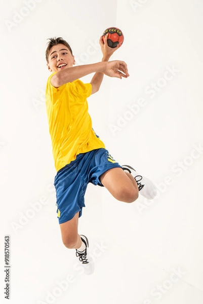 Obraz One happy handball player, teenager boy in studio isolated on white background. Hobby and healthy lifestyle