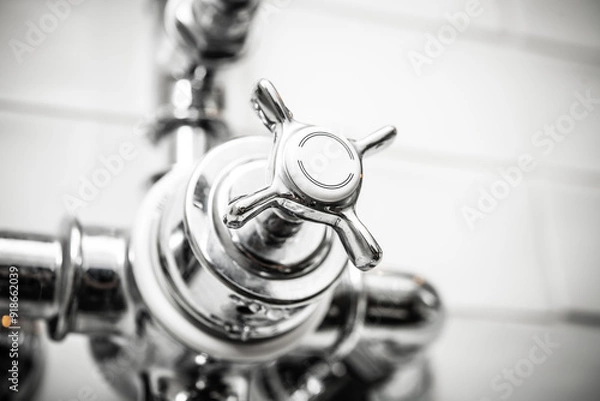 Fototapeta Close-Up of a Modern Chrome Faucet Handle with Smooth Finish in Bright Bathroom Setting for Home Renovation Projects