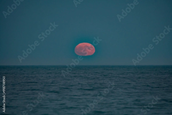 Fototapeta Full moon rises over the Atlantic ocean