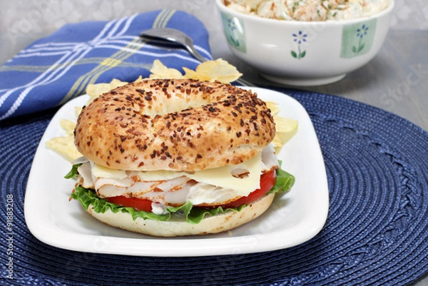Obraz Turkey, lettuce, tomato and swiss cheese sandwich on an onion ba