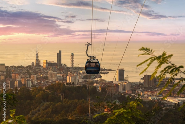 Fototapeta Beautiful view of the city of Batumi in Georgia, descent of the funicular to the bottom at sunset with a view of the city