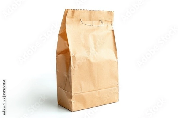 Fototapeta A single brown paper bag placed on a clean white surface, suitable for food or document storage