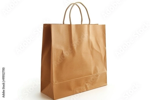 Fototapeta A simple brown paper bag placed on a clean white surface