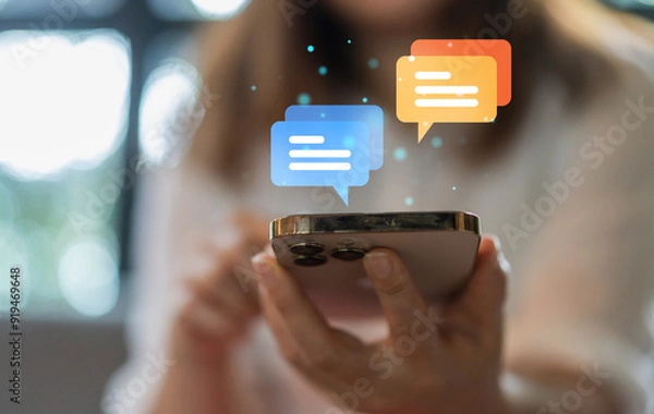 Fototapeta Human hand using smartphone typing Live chat chatting and social network concepts, chatting conversation working at home in chat box icons pop up. Social media marketing technology concept