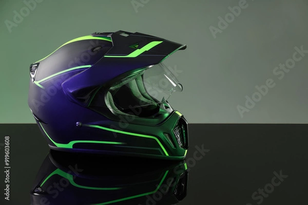 Obraz Modern motorcycle helmet with visor on mirror surface against grey background. Space for text