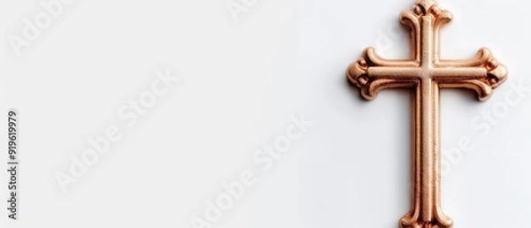 Fototapeta  A cross in tight focus against a white backdrop, reflecting its image on the side