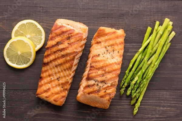 Obraz Grilled salmon with lemon, asparagus on the wooden background