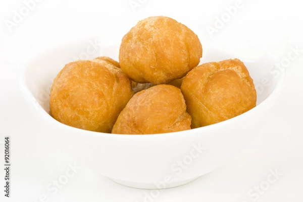 Fototapeta Johnny Cakes - Jamaican fried dumplings in a white bowl.
