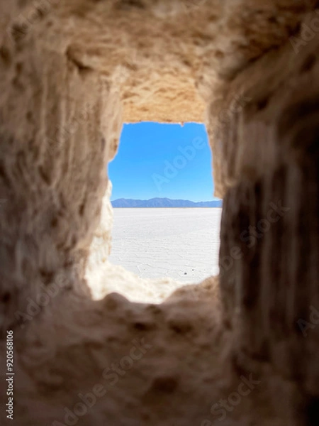 Fototapeta View of the salt marsh through the window of a house made of salt blocks. Salinas Grandes, Argentina