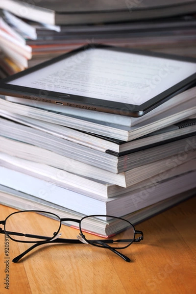 Obraz  tablet put on book pile