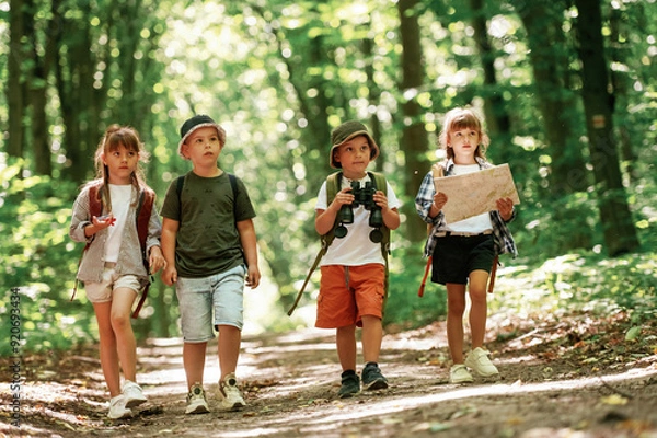 Fototapeta Walking together. Kids in forest at summer daytime