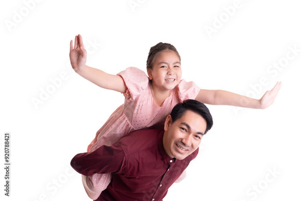 Fototapeta Playful moment between asian father and his adorable daughter as she rides on his back with outstretched arms, symbolizing fun, joy, and a strong father-daughter bond 