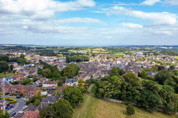 Fototapeta Aerial drone photo of the beautiful town of Leyburn which is a market town and civil parish in North Yorkshire in the UK, showing the houses in the town from above in the summer time
