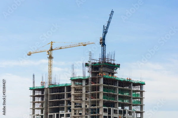 Fototapeta Building crane and building under construction