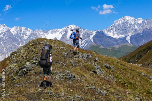 Fototapeta Group of tourists with large backpacks are on mountain