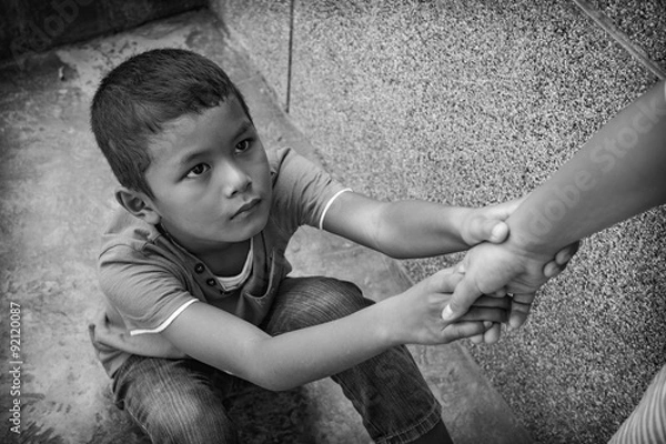 Fototapeta A young Asian boy who is scared and alone, he is at high risk of being physically, mentally and sexually abused and trafficked. His mental health is of great concern.