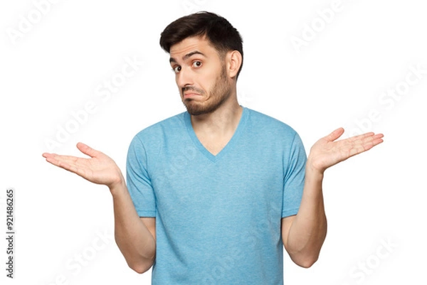 Fototapeta I don't know. Portrait of young confused man in blue t-shirt standing and shrugging shoulders, spreading hands
