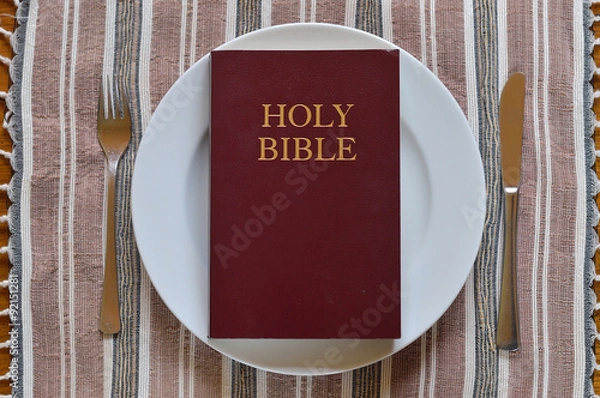Fototapeta Bible on a dinner plate with silverware in lent