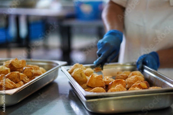 Obraz A female cook prepares traditional Bulgarian pasta snacks called cheese pie - banitsa