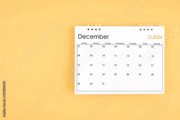 Fototapeta December 2024 desk calendar on yellow color background, position with copy space.